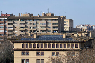 building with solar panels on the roof to save electricity and heating.