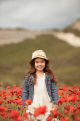 Pretty little girl on a poppy field, outdoor © rimmdream