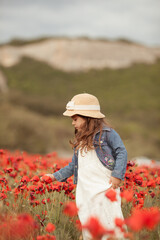 Pretty little girl on a poppy field, outdoor © rimmdream