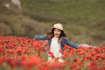 Pretty little girl on a poppy field, outdoor © rimmdream