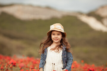 Pretty little girl on a poppy field, outdoor © rimmdream