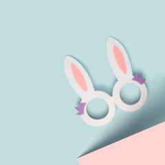 Rabbit ears celebration glasses on a two tone pastel background. Happy Easter minimal flat lay