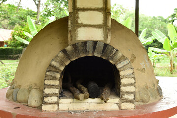 Clay oven in the rural garden, to make homemade wholemeal bread, built with mud, stones and bricks.