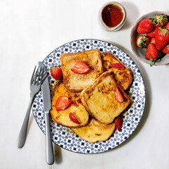 Stockpile of french toasts with fresh strawberries