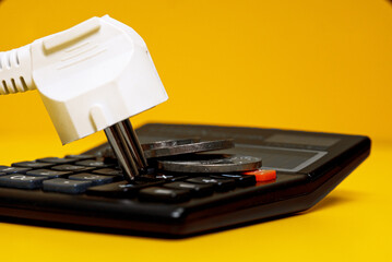 Electricity growth concept. Calculator and AC power plug.