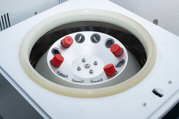 opened laboratory centrifuge with samples inside,  a centrifuge rotor in lab for medical and scientific research.