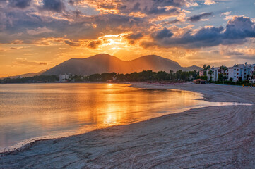 Beach of Alcudia town in sunset time