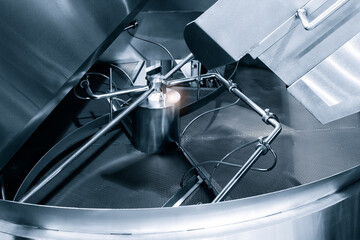 Industrial open mixer with knives in food industry close-up