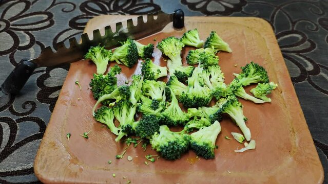 Broccoli finely chopped on aplastic vegetable cutter for stir fry