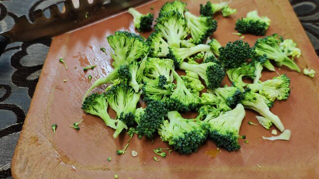 Broccoli finely chopped on aplastic vegetable cutter for stir fry