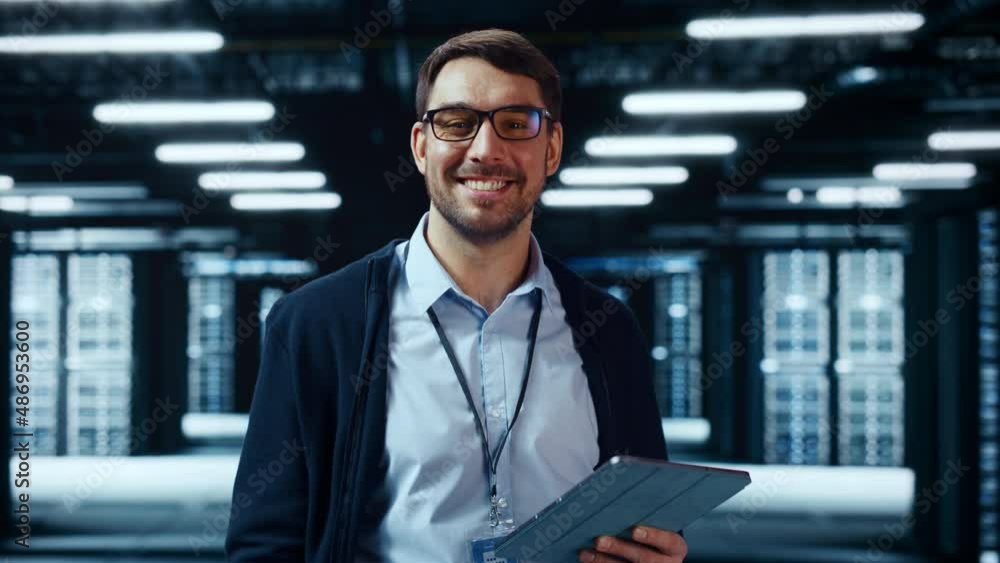 Aufkleber Portrait of a Bearded Handsome Caucasian IT Engineer in Glasses Standing with Tablet and Posing in the Middle of a Working Data Center Server Room with Server Computers Working on a Rack.