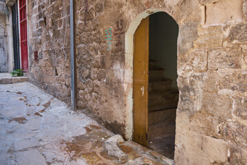 Fototapeta na wymiar Doors of middle-eastern town. Narrow paved street of Mardin, Turkey