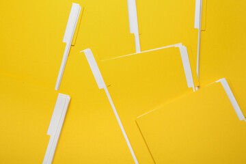 Many yellow files with documents as background, top view