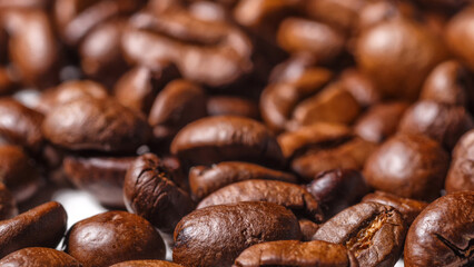 Freshly roasted coffee beans background.Dark roasted coffee beans with scoop on wooden background.