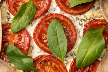 Close-up of vegetarian spinach pizza galette with feta cheese.