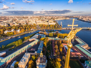 Russia, St. Petersburg, Aerial landscape of Peter and Paul cathedral at sunset, walls of fortress, Golden autumn, panorama landscape, golden spire with cross and angel, drawbridges, river Neva