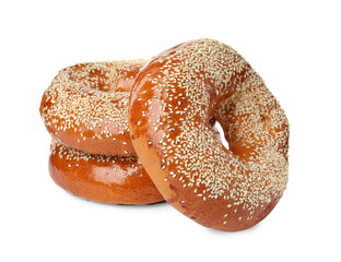 Delicious fresh bagels with sesame seeds on white background