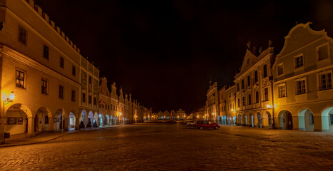 Naklejka na ściany i meble Telc town in winter night with orange street lamps
