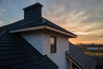 Unfinished house with aerated lightweight concrete walls and wooden roof frame covered with...