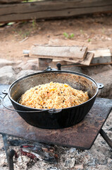 Cauldron with finished pilaff with a rice, carrot and mutton meat. Rice pilaf series, vertical image