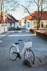 Fototapeta premium Bicycle parking station with bike is in the Kuressaare town at spring season, Estonia, vertical image