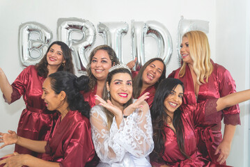 Bride and bridesmaids together in portrait against white background written Bride.