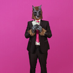 A well dressed werewolf holding 50-dollar bills