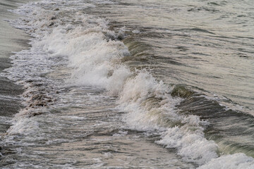 Sea waves on the beach at sunset