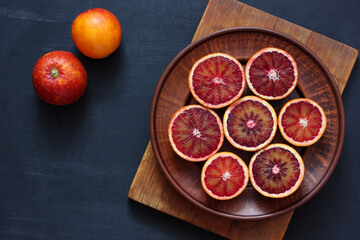 Bloody red oranges on a plate, top view.