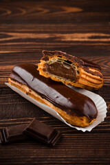Traditional french dessert eclair with custard and chocolate icing Sweet pastry products