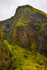 The birdlife-rich, towering green hills surrounding the village of Vík í Mýrdal, South Coast, Iceland