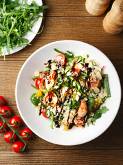 Salad with spinach, arugula, salmon, almonds, balsamic vinegar, cheese. Homemade food. The concept of delicious and healthy food. Wooden background. Top view. To close. Healthy eating. Keto diet