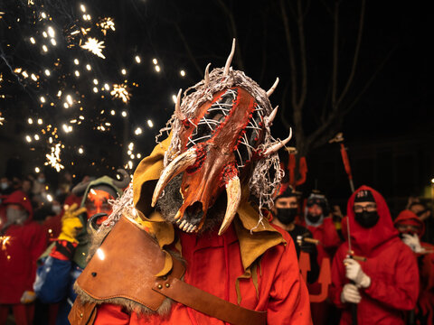Valencia, Spain - 11 February, 2022: Man with a demon mask looking at camera in Spanish traditional festival, called Correfoc