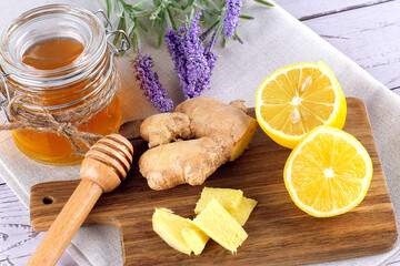 Fototapeta premium Jar of honey, lemon and ginger on wooden backround