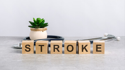 stroke word written on wooden blocks and stethoscope on light gray background