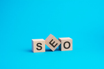 SEO text on wooden blocks, business concept, blue background