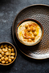 Overhead view of hummus dip with chickpeas and oil in a bowl