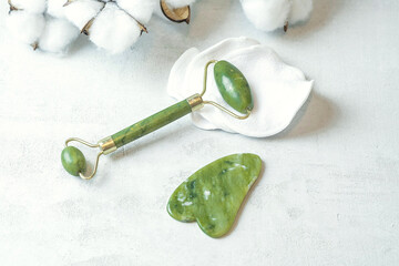 jade roller for facial massage gouache scraper brown bubble with serum , the concept of facial...