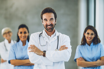 Doctor Standing With Arms Crossed And Looks At Camera