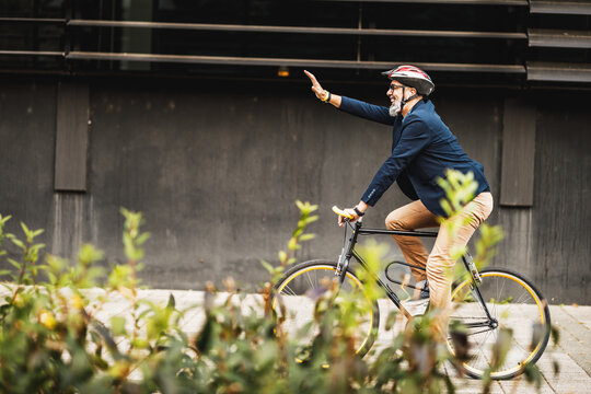 A Businessman Traveling To Work With A Bike