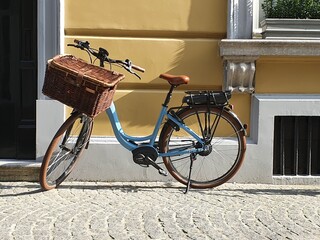 blue bicycle with a basket on a street
