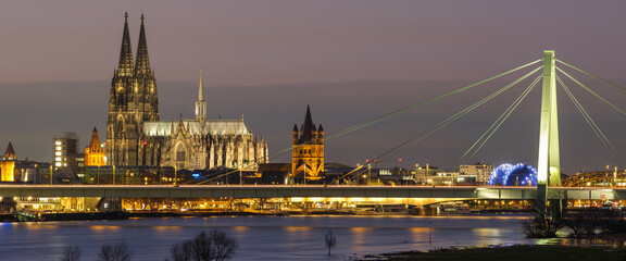 Cologne Cathedral and Church Gross St Martin along river rhine by night in Germany