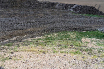 View of area where is upper layer of soil with grass taken away.