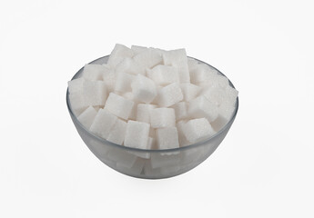 White sugar cubes in a glass bowl, on a white background