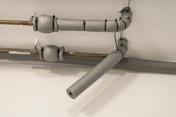 Water pipe with insulation in house over ceiling.
