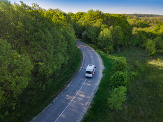 Fototapeta na wymiar minibus or minicoach on rual landscape road aerial