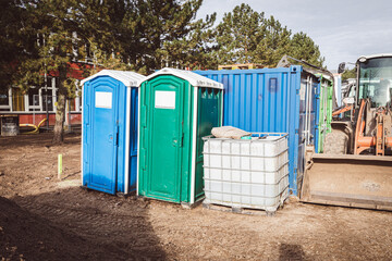 on a construction site there are two construction site toilets