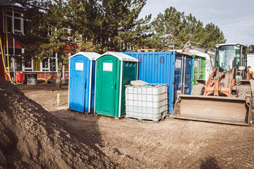 Fototapeta na wymiar on a construction site there are two construction site toilets