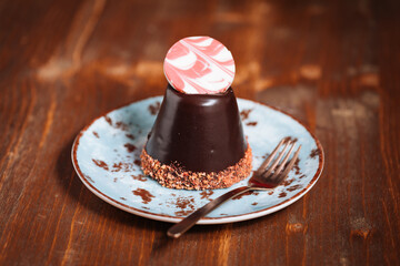 Decorated chocolate cake. Glazed and tasty dessert, great for celebration. Dark wooden background