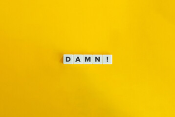 Damn Word on Letter tiles on Yellow Background. Minimal aesthetics.